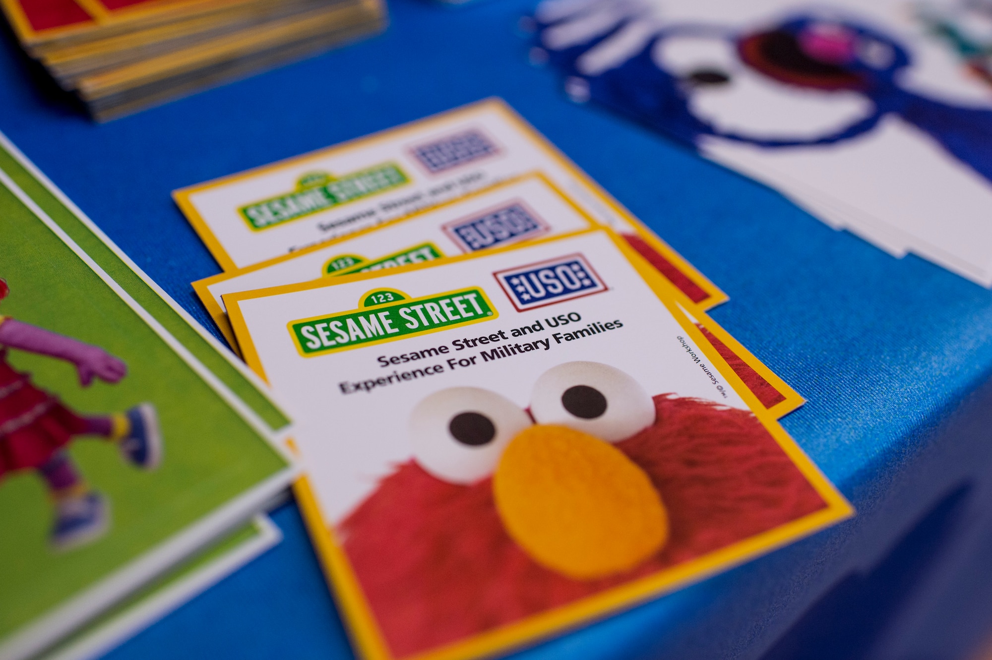 A pamphlet for the 2015 Sesame Street/USO Experience for Military Families tour is displayed on a table prior to the start of a show inside the Skelton Memorial Fitness Center July 11, 2015, at Spangdahlem Air Base, Germany. The six-month tour started in May and will wrap up in October 2015. (U.S. Air Force photo by Senior Airman Rusty Frank/Released)
