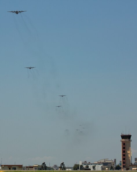 C-130 Hercules aircraft fly over Yokota Air Base, Japan, July 14, 2015. Nine C-130s flew in formation to practice airlift tactics and procedures. (U.S. Air Force photo by Osakabe Yasuo/Released)