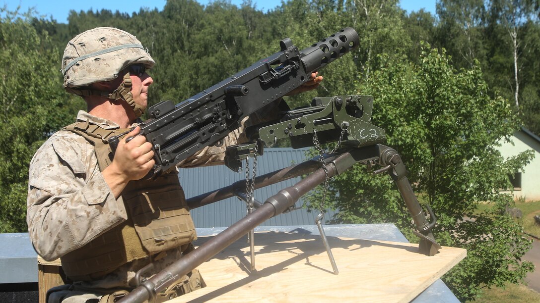 A U.S. Marine with Special-Purpose Marine Air-Ground Task Force Crisis Response-Africa emplaces a machine gun on the roof of a notional American Embassy during a training exercise in the urban training facility in Baumholder, Germany, July 6, 2015. More than 78 Marines and sailors conducted the full-mission rehearsal, which demonstrated the unit’s ability to rapidly deploy and conduct embassy reinforcement. 