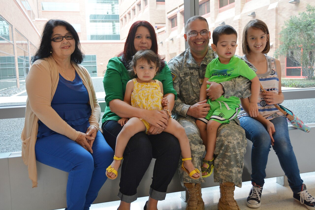 The Collado family poses for a photo at San Antonio Military Medical Center, July 7, 2015. From left, Maria Hernandez, Alma Collado, 1-year-old Adriana, Army Maj. Jose Collado, Jose Jr., and 11-year-old Melissa. U.S. Army photo by Robert T. Shields