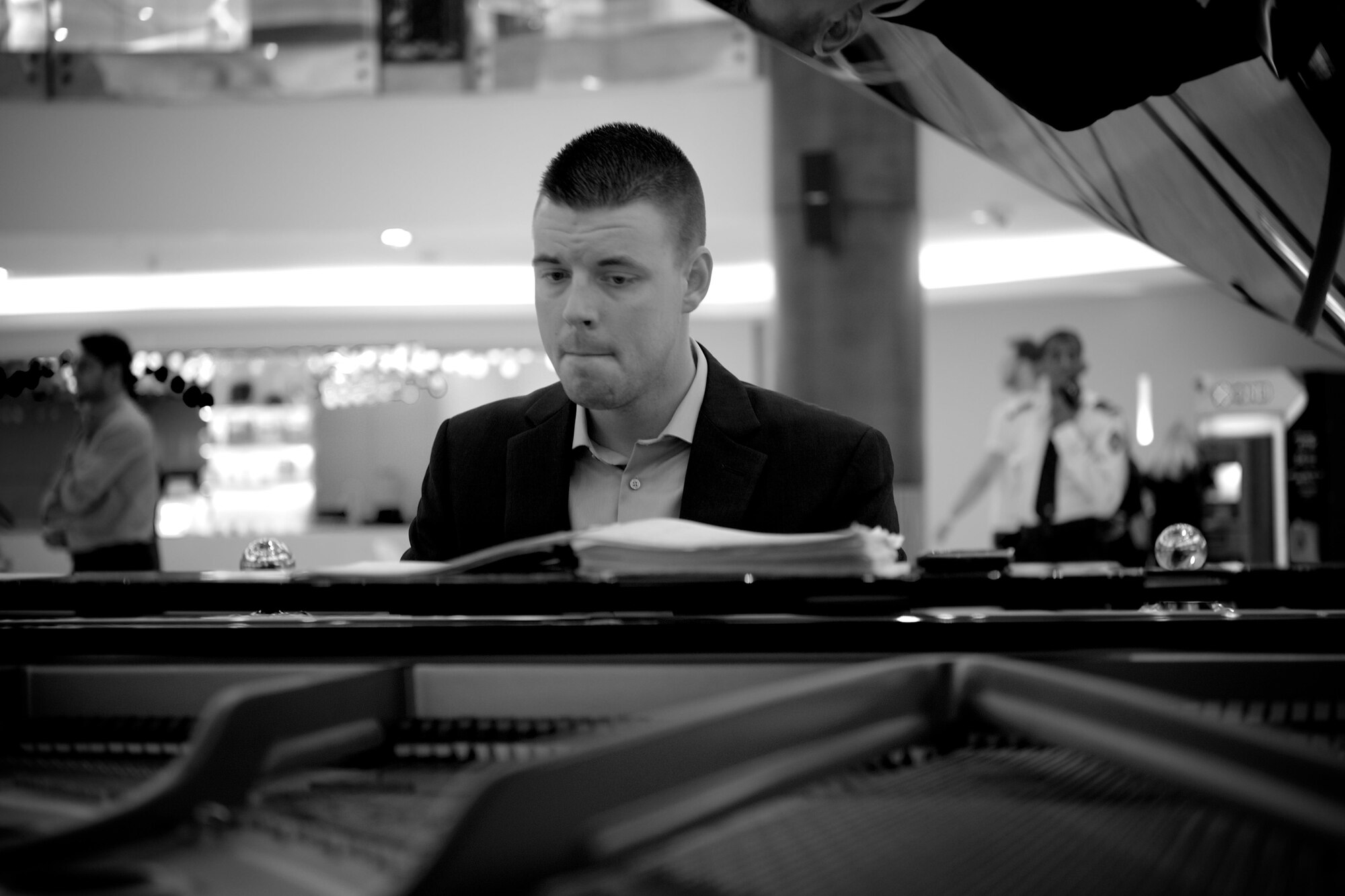 U.S. Air Force Airman 1st Class Cody Peterson, Air Forces Central Command band keyboardist, plays a piano during a performance at Lagoona Mall in Doha, Qatar, June 5, 2015. The band traveled into local communities to perform American music for the local population, which gave the band an opportunity to entertain and educate the local population about American musical styles while interacting and supporting country partnerships. (U.S. Air Force photo by Airman 1st Class Nathan Martin/Released)