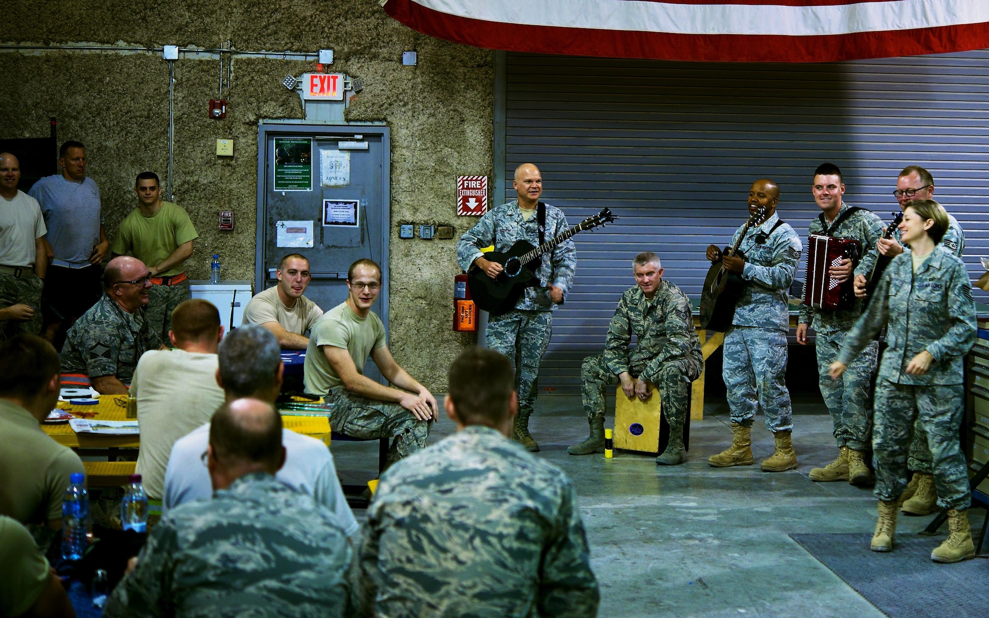 The Air Forces Central Command band plays music for Service members during a performance at Al Udeid Air Base, Qatar, June 17, 2015. The band visited work stations to perform and boost morale of the working Airmen. (U.S. Air Force photo by Airman 1st Class Nathan Martin/Released)
