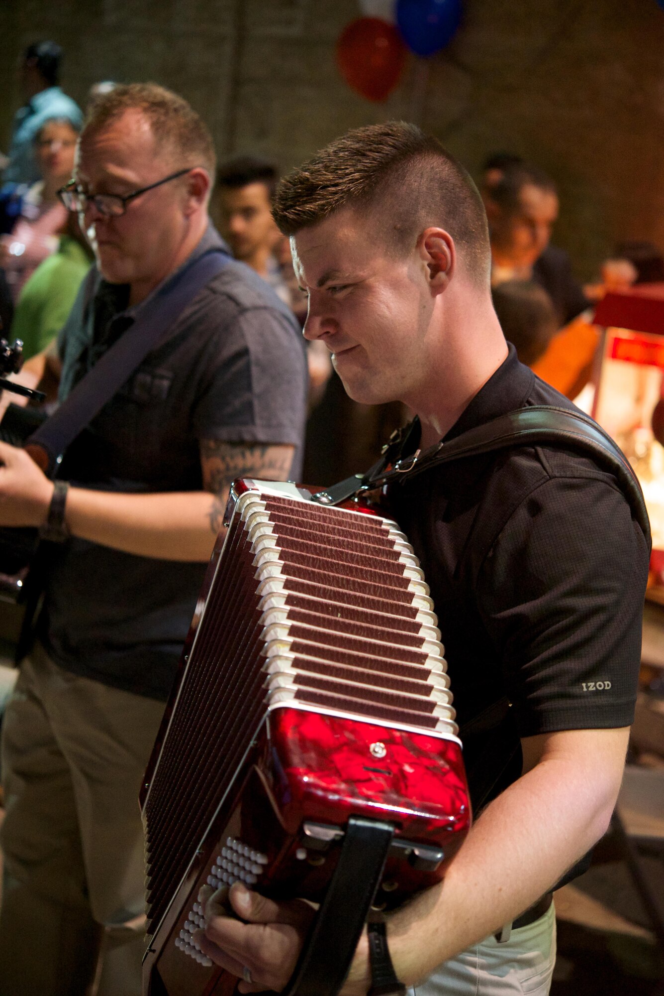 U.S. Air Force Airman 1st Class Cody Peterson, Air Forces Central Command band keyboardist, plays an accordion during a performance at American Language Center in Amman, Jordan, July 1, 2015. The center partnered with the United States Embassy to teach the local communities about 4th of July traditions in America. The AFCENT band supported the event by providing popular American music for the enjoyment of the local community. (U.S. Air Force photo by Airman 1st Class Nathan Martin/Released)