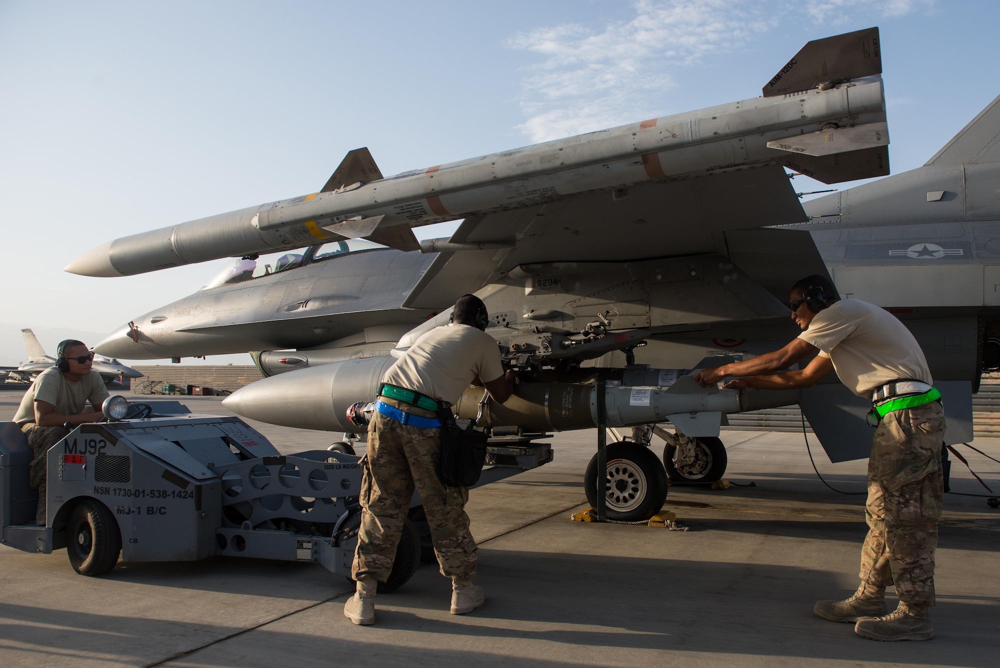 U.S. Airmen from the 455th Expeditionary Aircraft Maintenance Squadron’s weapons flight load munitions onto an F-16 Fighting Falcon aircraft at Bagram Airfield, Afghanistan, July 13, 2015. The F-16 is a multi-role fighter aircraft that is highly maneuverable and has proven itself in air-to-air and air-to-ground combat. Members of the Triple Nickel are deployed in support of Operation Freedom’s Sentinel and NATO’s Resolute Support mission. (U.S. Air Force photo by Tech. Sgt. Joseph Swafford/Released)