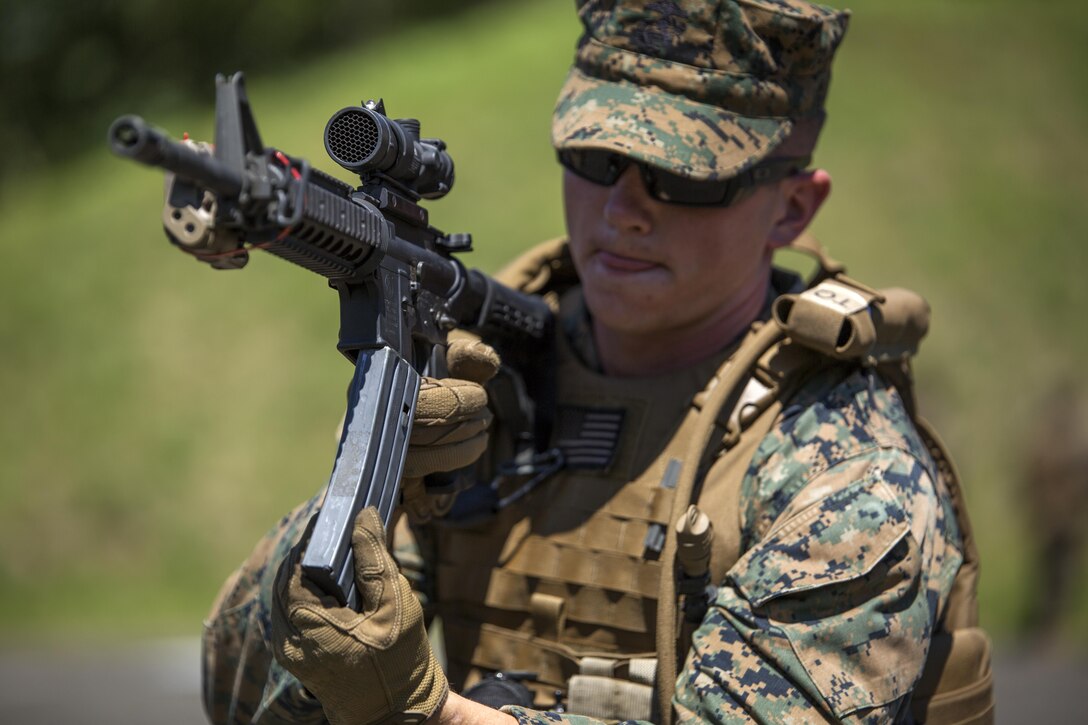 Lance Cpl. Brandon Robinson, a patrolman with the Provost Marshall’s Office aboard Marine Corps Air Station Iwakuni, Japan, performs a speed reload during Exercise Dragon Fire 2015, July 14, 2015, at Camp Fuji, Japan. Combat Logistics Company 36 conducts this annual exercise to test the Marine’s combat readiness as it is part of the Marine Corps foundation in the battlefield.