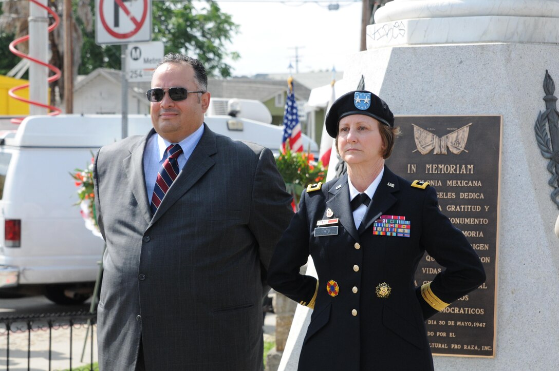 U.S. Army Maj. Gen. Megan Tatu, right, the commanding general of the 79th Sustainment Support Command, stands alongside California State Assembly Speaker John A. Perez at the All Wars Memorial in Cinco Puntos just prior to the 66th Annual Memorial Day Observance in East Los Angeles, May 27, 2013. (U.S. Army photo by Sgt. 1st Class Corey Beal/Released)