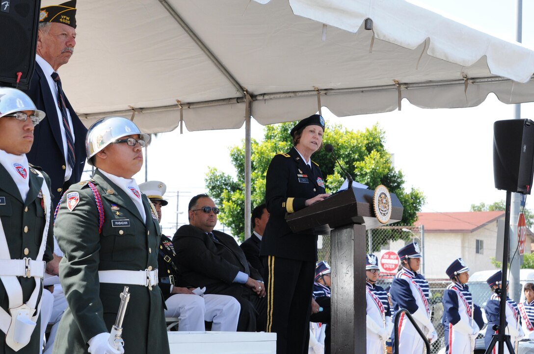 U.S. Army Maj. Gen. Megan Tatu, center, the commanding general of the 79th Sustainment Support Command, speaks to elected officials, veterans and more than 300 community members during the 66th Annual Memorial Day observance at Cinco Puntos in East Los Angeles, May 27, 2013. (U.S. Army photo by Sgt. 1st Class Corey Beal/Released)