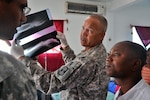 Army Col. Paul Phillips, an Army Reserve surgeon with Task Force Bon Voizen, discusses the prognosis of a traffic accident victim with a Haitian physician at St. Nicolas Hospital May 19, 2011. New Horizons, Haiti 2011 - Task Force Bon Voizen is a Commander, U.S. Southern Command-sponsored, U.S. Army South-conducted, joint foreign military interaction/humanitarian exercise under the command of the Louisiana National Guard.