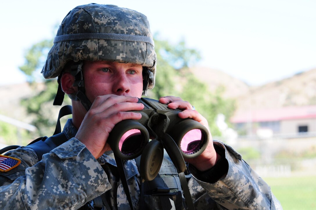 Cpl. Bryan Ohlendorf, a water purification specialist with the 383rd Quartermaster Company, 451st Expeditionary Sustainment Command, uses binoculars for a Mystery Event during the Best Warrior Competition hosted by the 79th Sustainment Support Command at Camp Pendleton, Calif., April 18, 2015. The Best Warrior Competition seeks out the best candidate that defines a U.S. Army Soldier by testing Soldiers physically and mentally. The competition will consist of one enlisted Soldier and one noncommissioned officer from four separate one-star commands, which fall underneath the command and control of 79th SSC. At the conclusion, one Soldier and one NCO will be named the 79th SSC Best Warrior and represent the command in the U.S. Army Reserve Best Warrior Competition held at Fort Bragg, N.C., May 4-8, 2015.  (U.S. Army photo by Spc. Heather Doppke/released)
