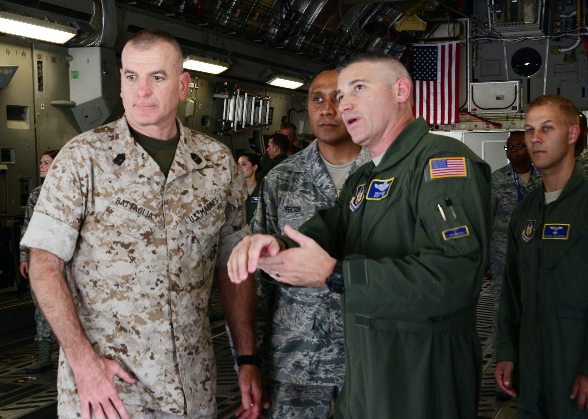 Master Sgt. Brian Dawes, 89th Airlift Squadron loadmaster, explains to Marine Corps Sgt. Maj. Bryan B. Battaglia, the senior enlisted advisor to the chairman of the Joint Chiefs of Staff, the various aspects of the cargo area of the C-17 Globemaster III during his visit to the 445th Airlift Wing July 11, 2015. While at the wing, Battaglia participated in demonstrations by the 445th Aeromedical Evacuation and Aeromedical Staging Squadrons and watched the 87th Aerial Port Squadron load cargo on the aircraft during a training scenario. (U.S. Air Force photo/Senior Airman Joel McCullough)