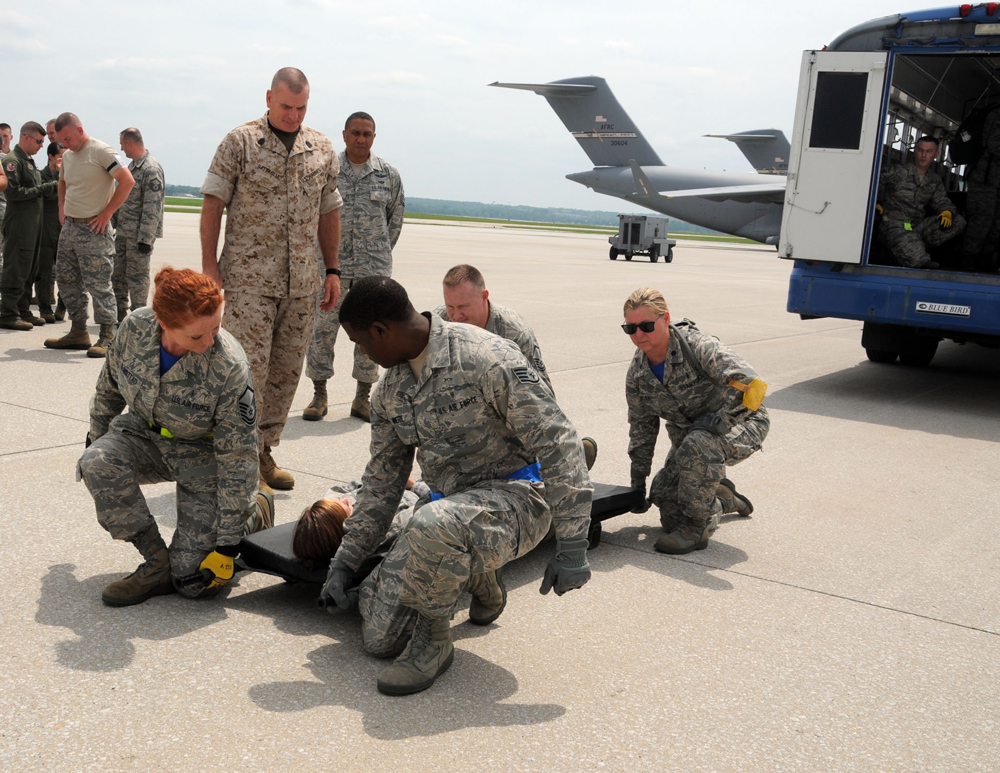 Marine Corps Sgt. Maj. Bryan B. Battaglia, the senior enlisted advisor to the chairman of the Joint Chiefs of Staff, watches Airmen from the 445th Aeromedical Staging Squadron demonstrate the proper techniques for litter carry during his visit here July 11, 2015. Battaglia visited with wing Airmen while touring a C-17 Globemaster III and participated in demonstrations by the 445th Aeromedical Evacuation Squadron, ASTS and 87th Aerial Port Squadron. (U.S. Air Force photo/Tech. Sgt. Anthony Springer)