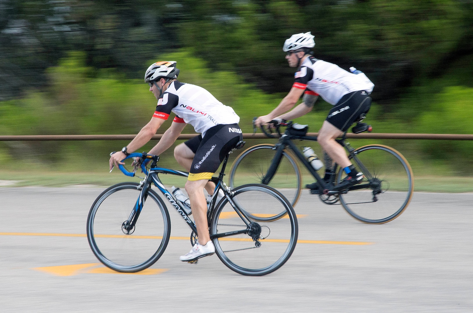 Rambler 120 participants race down a hill of the 22-mile bike race portion of the annual Rambler 120 Competition Sept. 20 at Joint Base San Antonio Recreation Park at Canyon Lake. The Rambler 120, which is hosted by the 502nd Force Support Squadron, features four- and eight-person teams that engage in a friendly, but hard-fought, competition that challenges participants with a 22-mile bike race, 6-mile run, 2-mile raft race and a mystery event. (U.S. Air Force photo by Johnny Saldivar)