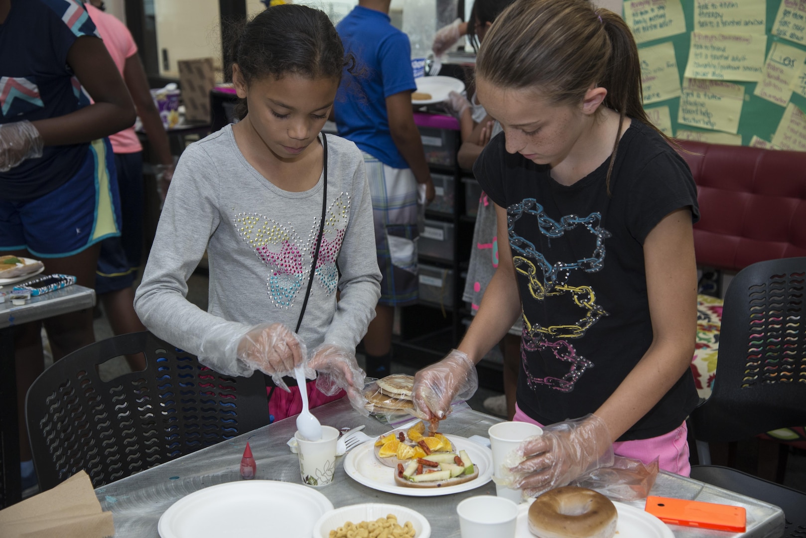 Sofia Jackson  and Cheyenne Gramlick  prepare their dish, “spicy-yummy-breakfast”, for an “Iron Chef” cooking contest July 9, 2015 at the Joint Base San Antonio-Randolph Youth Center. More than 500 children are involved in activities and programs provided by Randolph Youth Programs each year. (U.S. Air Force photo by Airman 1st Class Stormy Archer/Released)