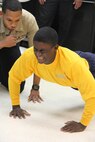 Petty Officer Joshua Francis, Junior Enlisted Association vice president, left, encourages Seaman Jacob Barnes, during the pushup contest on Friday at the Naval Health Clinic, Quantico.