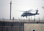 An HH-60M medevac helicopter crew of Company C, 3rd Battalion, 126th Aviation Regiment, evacuates an injured Soldier from Contingency Operating Site Cobra, Iraq, April 4, 2011. The medevac crew flew in low visibility and blowing dust conditions in order to reach the injured Soldier and safely transport him to a medical facility.