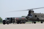 A CH-47 Chinook helicopter from Company B, 2nd Battalion 238th Aviation, based in Peoria Illinois is being refueled while on the ramp at the Iowa Air National Guard base in Sioux City, Iowa. Members of the 185th Air Refueling Wing based in Sioux City are refueling the helicopter while it is still running. “Hot Refueling” saves time for the air crew who will return to flooded areas along the Missouri River. National Guard Soldiers and from South Dakota, Illinois and Iowa are assisting local and state authorities in Western Iowa and South East South Dakota to protect private properties and municipalities along the swollen Missouri River. 
USAF Photo MSgt Vincent De Groot 185th Air Refueling Wing Iowa Air National Guard (released)
