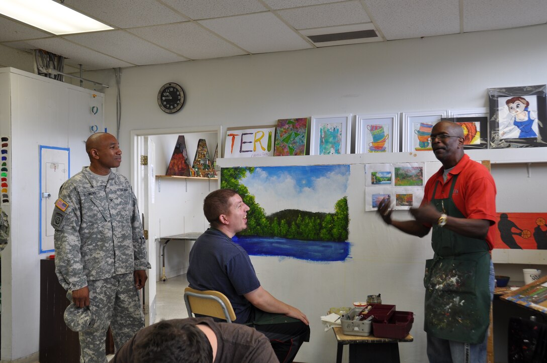 Innovative Readiness Training leaders, Col. Eric Flowers and Maj. Anna Hill, listen as Bill Hopkins, Director of Art, describes the art programs at TERI. (U.S. Air Force photo/ Capt. Meghan Liemburg-Archer)
