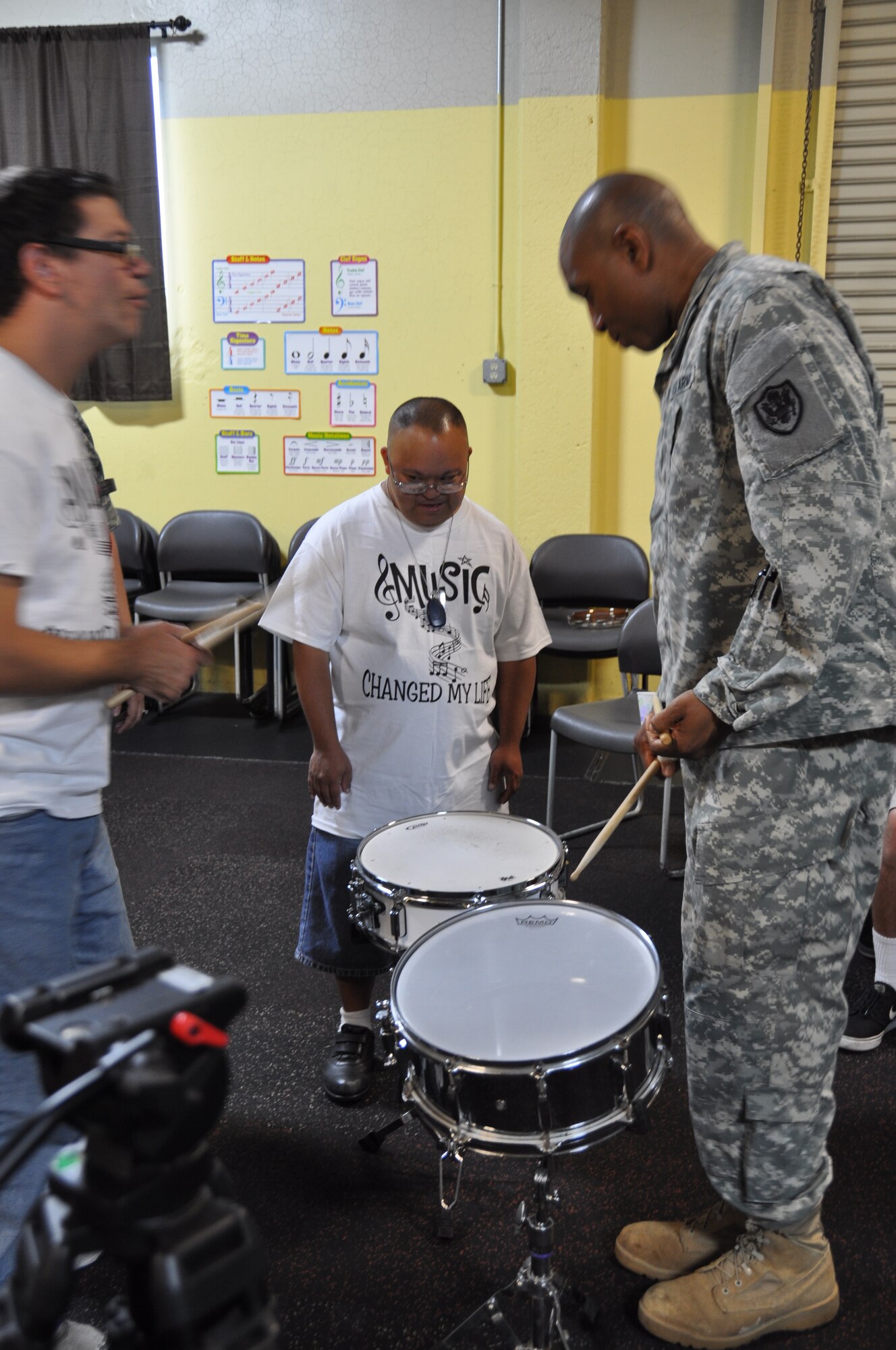 Col. Eric Flowers, deputy director for Manpower for OSD, plays drums with TERI students. (U.S. Air Force photo/ Capt. Meghan Liemburg-Archer)