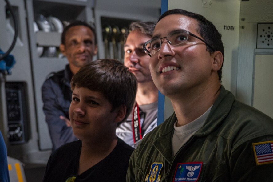 Senior Airman Christiane Roman is all smiles as visitors wait to tour the cockpit of a C-17 at Royal Naval Air Station Yeovilton International Air Day July 11, 2015. Recognized for “Best Static Display” at the air show, Airmen from the 315th Airlift Wing at Joint Base Charleston, S.C. delivered military pride, strength and technology with a C-17 and gave tours of the aircraft to more than 2,000 people. The air show marked 75 years of existence for RNAS Yeovilton and provided the 315th AW an international stage to showcase its Airmen, aircraft and partnership with the United Kingdom. Roman is a loadmaster with the 701st Airlift Squadron. (U.S. Air Force photo by Tech. Sgt. Shane Ellis)