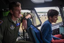 1st Lt. Ryan Grant gives a tour in the cockpit of a C-17 at Royal Naval Air Station Yeovilton International Air Day July 11, 2015. Recognized for “Best Static Display” at the air show, Airmen from the 315th Airlift Wing at Joint Base Charleston, S.C. delivered military pride, strength and technology with a C-17 and gave tours of the aircraft to more than 2,000 people. The air show marked 75 years of existence for RNAS Yeovilton and provided the 315th AW an international stage to showcase its Airmen, aircraft and partnership with the United Kingdom. Grant is a pilot with the 701st Airlift Squadron.  (U.S. Air Force photo by Tech. Sgt. Shane Ellis)