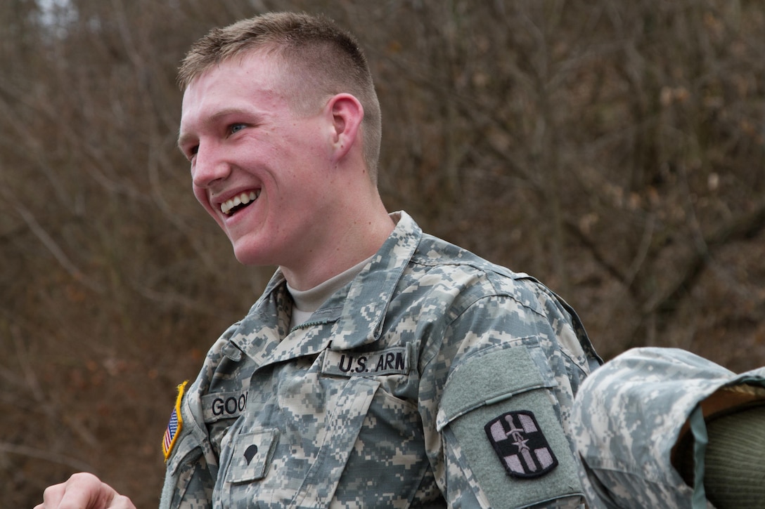 Spec. Shawn Goodwin smiles for the medics at the end of the road march event during the 807th Medical Command Best Warrior competition at Wendell H. Ford Regional Training Center near Greenville, Ky., March 24. The 807th will award the best warrior title to one noncommissioned officer and one junior enlisted Soldier to compete in the U.S. Army Reserve Command Best Warrior competition. (U.S. Army Photo by Sgt. 1st Class Adam Stone)