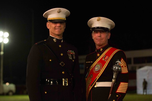 Chief Warrant Officer 3 Bryan P. Sherlock, band officer, U.S. Marine Corps Forces, Pacific Band and Master Gunnery Sgt. Mark Gleason, bandmaster, pose for a photo after a military tattoo in Nuku'alofa, Tonga, July 8, 2015. A tattoo is comprised of military units both musical and operational, from different countries, performing musically as well as demonstrating military capabilities. (U.S. Marine Corps photo by Cpl. Brittney Vito/Released)