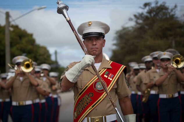 Master Gunnery Sgt. Mark Gleason, bandmaster and acting drum major, marches his Marines in a celebration parade in Nuku'alofa, Tonga July 8, 2015. The mission of the U.S. Marine Corps Forces, Pacific Band is to enhance the lives of military and civilian communities through quality musical performance. (U.S. Marine Corps photo by Cpl. Brittney Vito/Released)