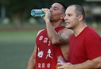 Senior Airman Eric Rios and Staff Sgt. Patrick Densford, 823rd Red Horse Squadron team members, recover during half time on Hurlburt Field, Fla., July 13, 2015. The 823rd RHS and the joint 1st Special Operations Component and Equipment Maintenance Squadrons tied 2-2 after one overtime round in the 2nd week of league play. There are 15 squadrons participating this season and regular season play is scheduled to last until Aug. 13 2015. (U.S. Air Force photo by Airman Kai White/Released)