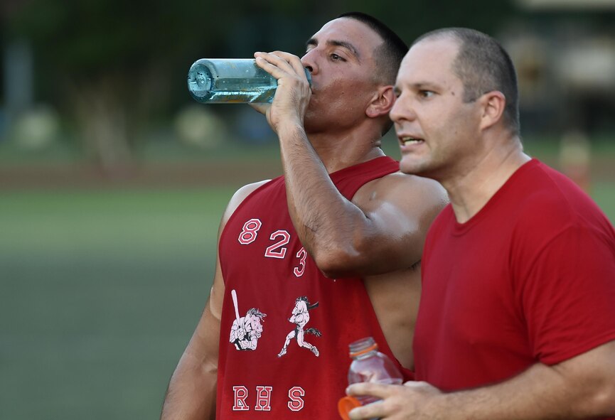 Senior Airman Eric Rios and Staff Sgt. Patrick Densford, 823rd Red Horse Squadron team members, recover during half time on Hurlburt Field, Fla., July 13, 2015. The 823rd RHS and the joint 1st Special Operations Component and Equipment Maintenance Squadrons tied 2-2 after one overtime round in the 2nd week of league play. There are 15 squadrons participating this season and regular season play is scheduled to last until Aug. 13 2015. (U.S. Air Force photo by Airman Kai White/Released)
