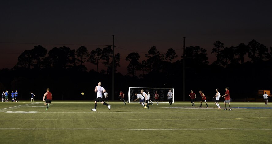Airmen from the 823rd Red Horse Squadron, the 1st Special Operations Component Maintenance Squadron and the 1st Special Operations Equipment Maintenance Squadron compete in an intramural soccer game on Hurlburt Field, Fla., July 13, 2015. The 823rd RHS and the joint 1st Special Operations CMS/EMS tied 2-2 after one overtime round in the 2nd week of league play. There are 15 squadrons participating this season and regular season play is scheduled to last until Aug. 13 2015. (U.S. Air Force photo by Airman Kai White/Released)