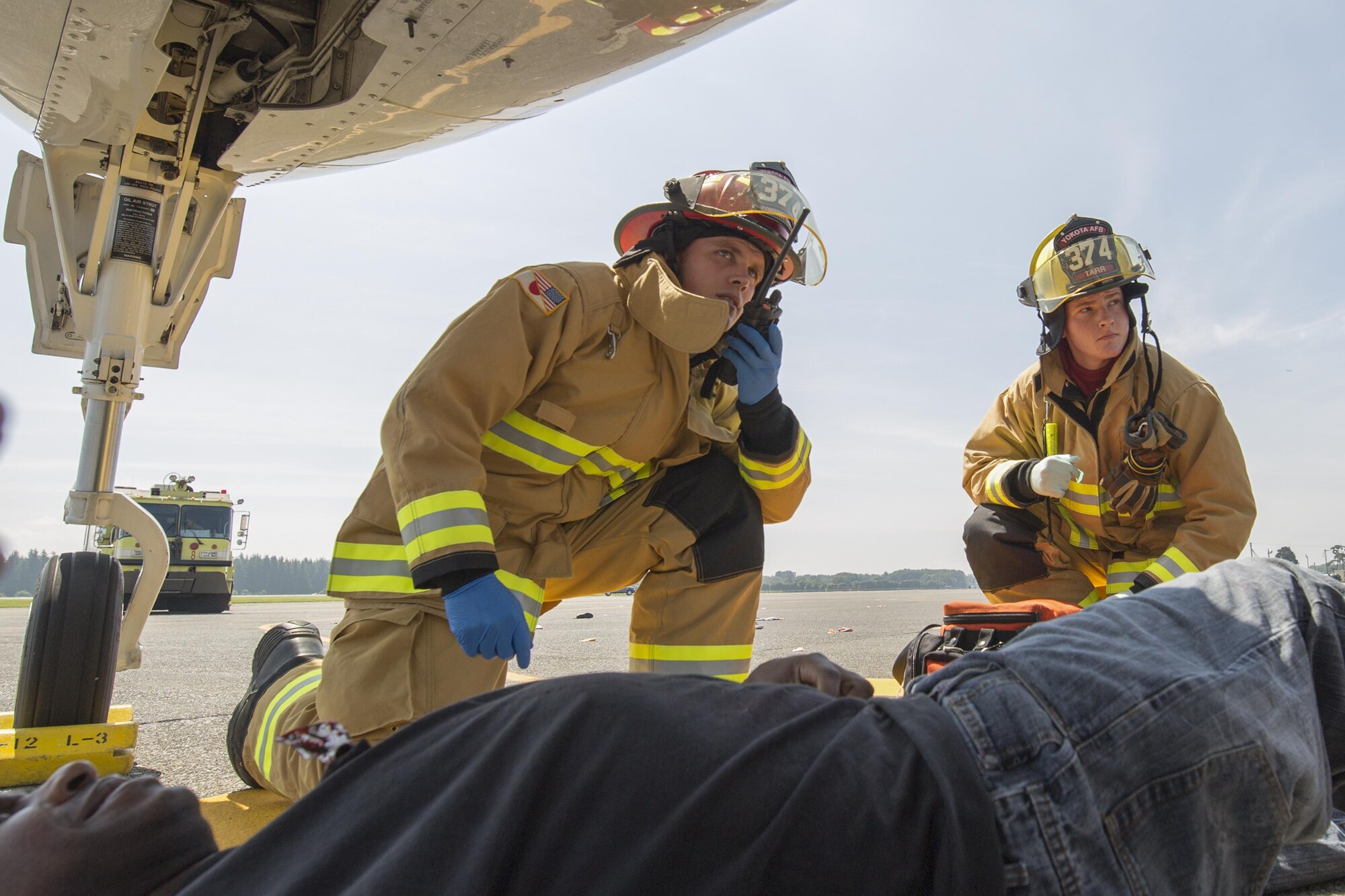 Yokota firefighters assess the situation during an Emergency Management Exercise at Yokota Air Base, Japan, July 13, 2015. Yokota conducted a Samurai Readiness Training Week to enhance readiness for real-world situations. (U.S. Air Force photo by Osakabe Yasuo/Released)