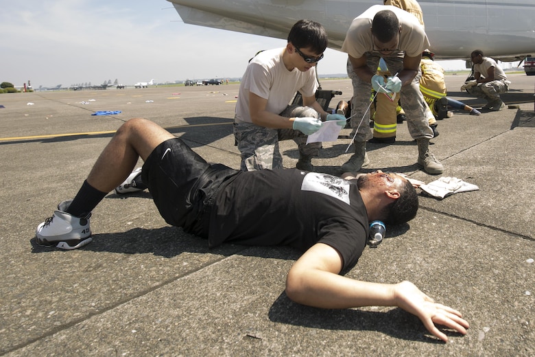 First responders from the 374th Medical Group arrive on scene and assess the situation during an Emergency Management Exercise at Yokota Air Base, Japan, July 13, 2015. The EME trained Yokota for possible real-world situations requiring response and communication between on-base organizations. (U.S. Air Force photo by Osakabe Yasuo/Released)
