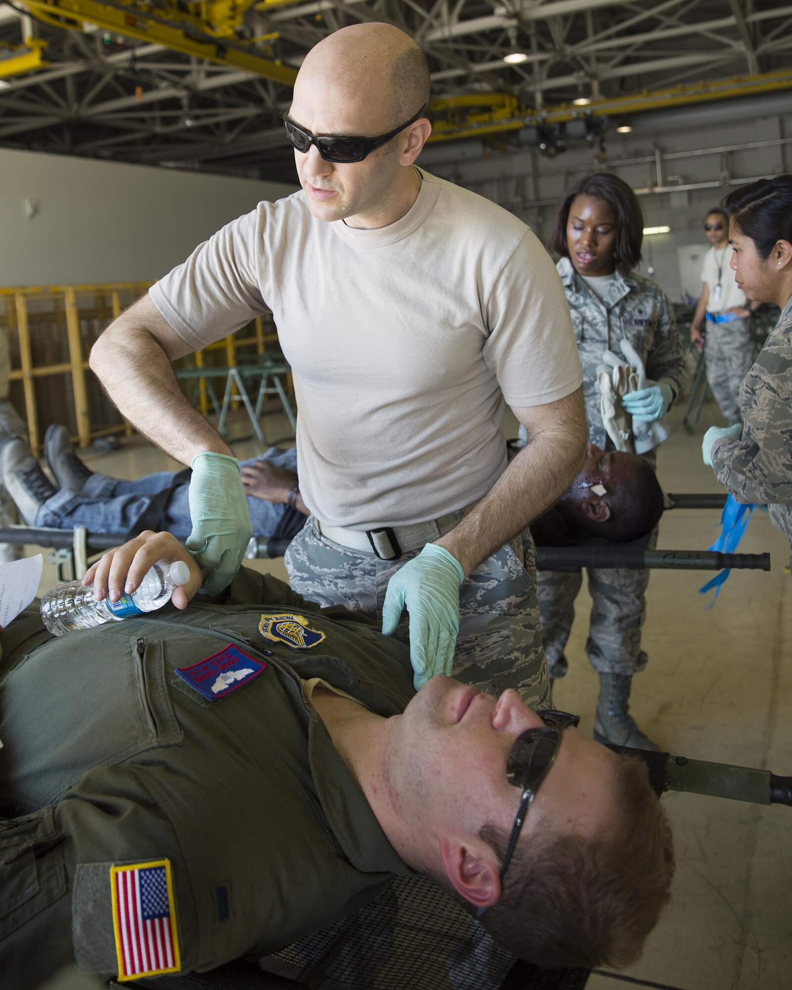 U.S. Air Force Capt. Robert Alexander, 374th Aerospace Medicine Squadron, checks the vitals of a simulated victim during an Emergency Management Exercise at Yokota Air Base, Japan, July 13, 2015. The EME trained Yokota for possible real-world situations requiring response and communication between on organizations. (U.S. Air Force photo by Osakabe Yasuo/Released)
