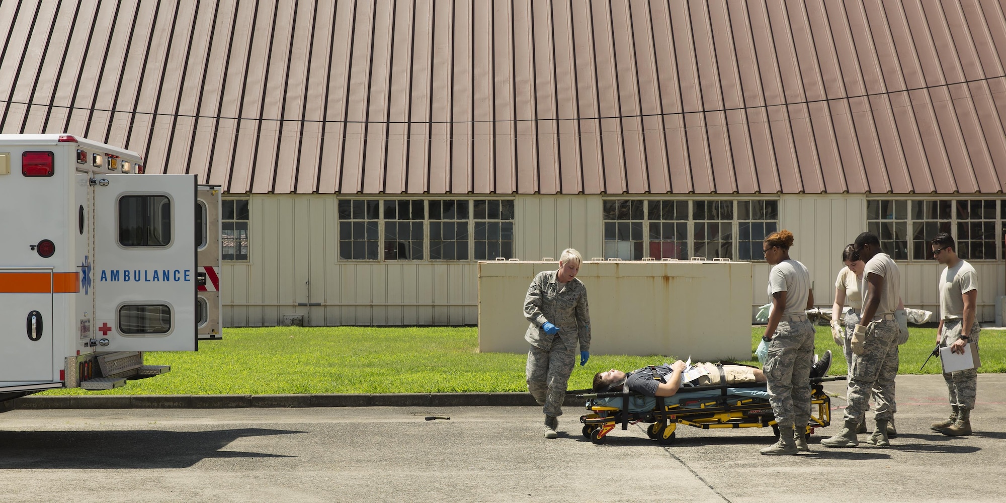 First responders from the 374th Medical Group prepare to transport a simulated victim onto an ambulance during an Emergency Management Exercise at Yokota Air Base, Japan, July 13 ,2015. The EME trained Yokota for possible real-world situations requiring response and communication between on-base organizations. (U.S. Air Force photo by Osakabe Yasuo/Released)