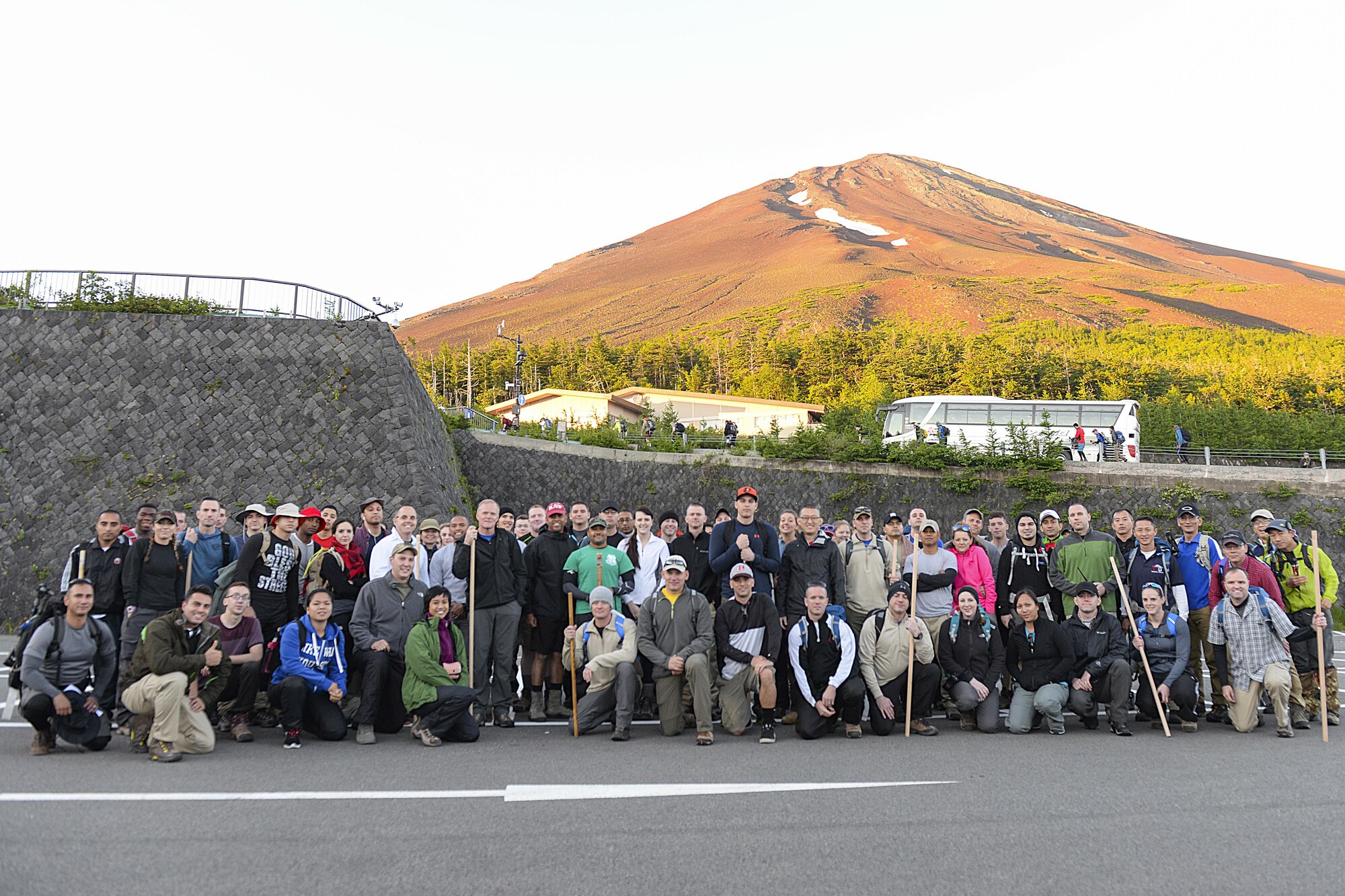 Members of Team Yokota pose with Chief Master Sergeant of the Air Force James A. Cody at the 5th station before beginning the hike to the summit of Mount Fuji, Japan, July 11, 2015. Hikers bus to the 5th station at nearly 7,000 ft. altitude before beginning the trek. (U.S. Air Force photo by Airman 1st Class Elizabeth Baker/Released)