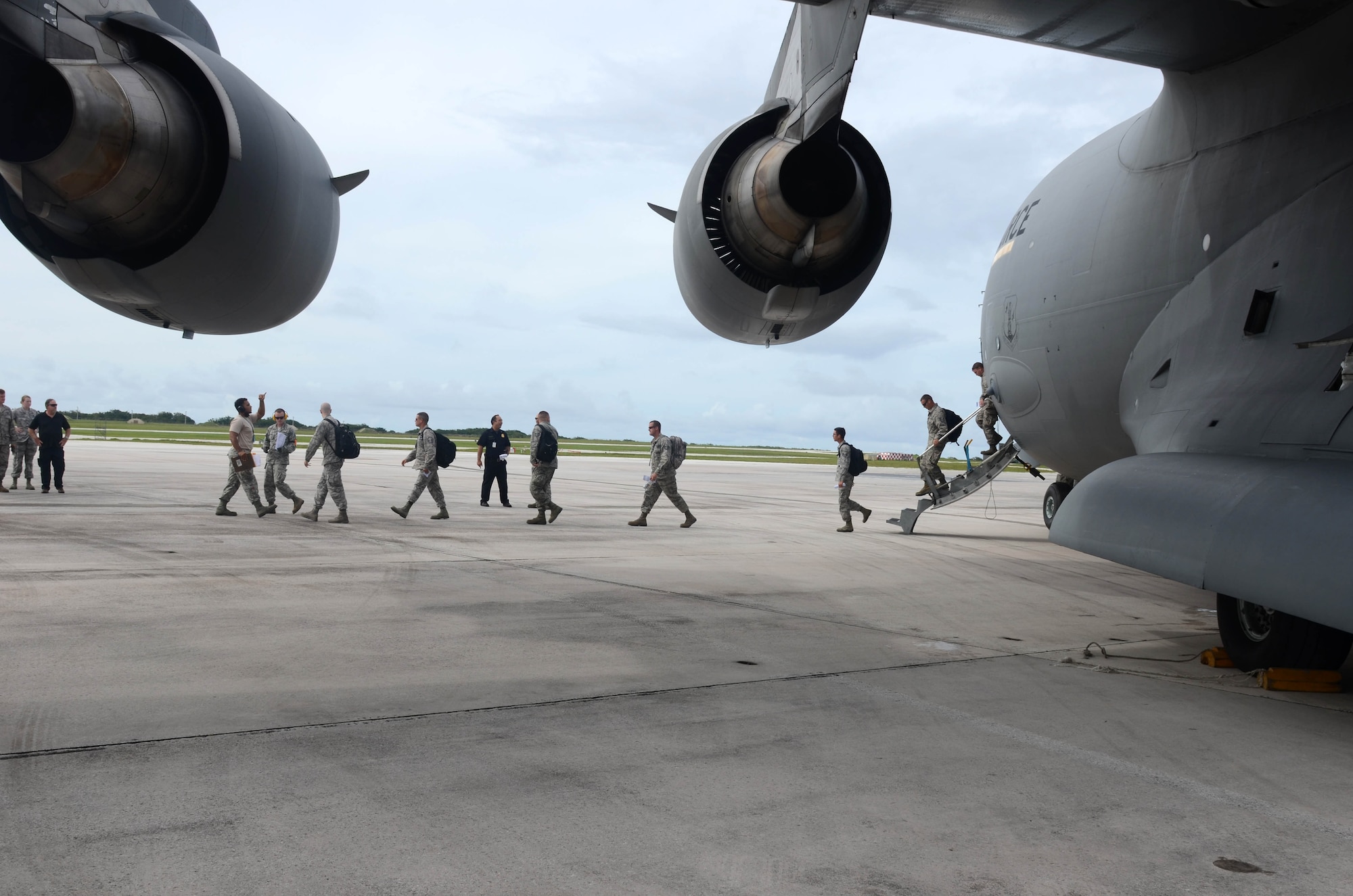 More than 125 Department of Defense members and contractors arrive at Andersen Air Force Base, Guam, July 15, 2015, after evacuation from Wake Island in preparation for potential surges caused by Typhoon Halola. An evacuation mission such as this highlights Pacific Air Forces flexibility to generate air response quickly across the theater, which is a key component to air power. (U.S. Air Force photo by Airman 1st Class Alexa A. Henderson/Released)