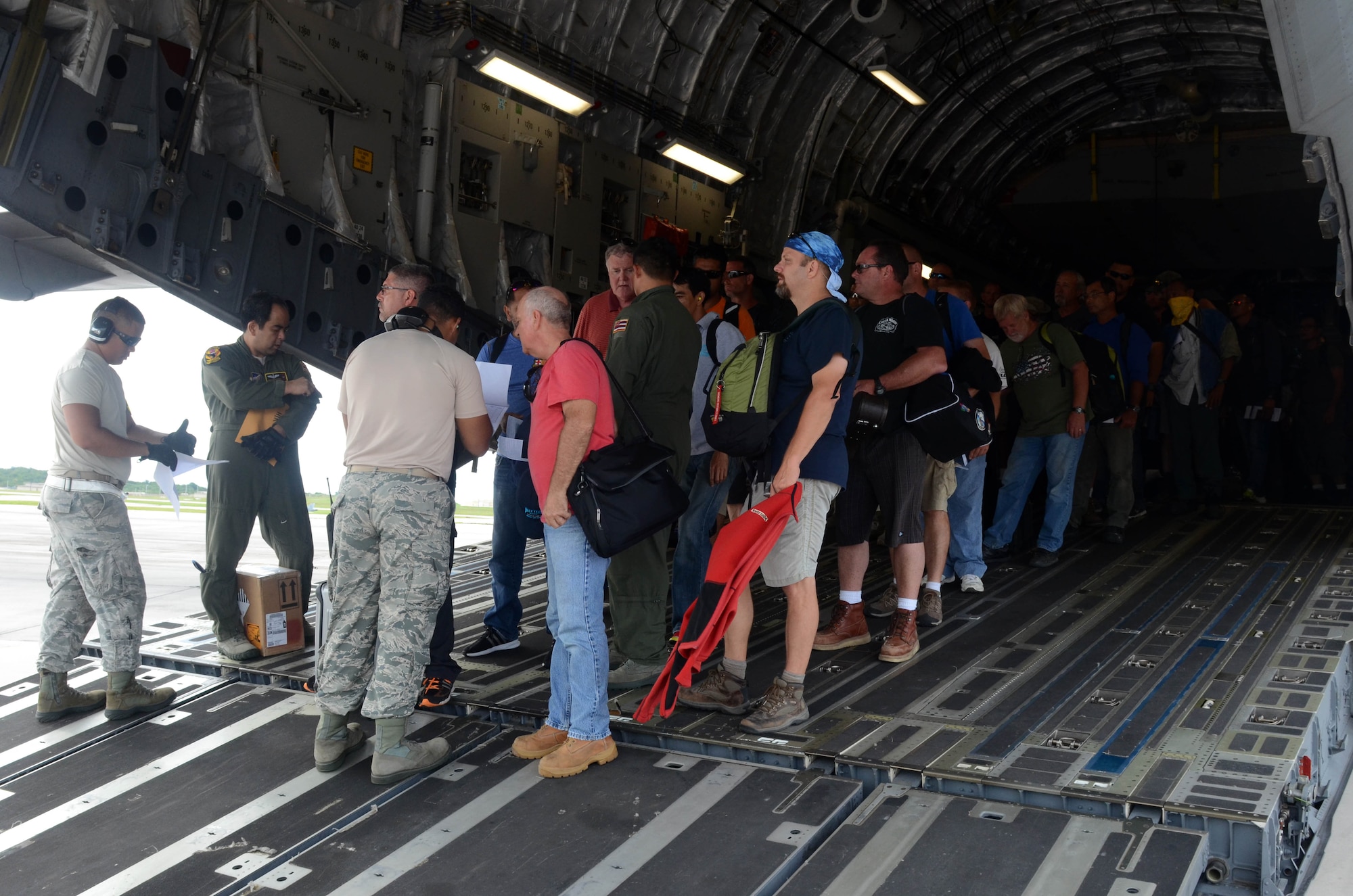 More than 125 Department of Defense members and contractors arrive at Andersen Air Force Base, Guam, July 15, 2015, after evacuation from Wake Island in preparation for potential surges caused by Typhoon Halola. An evacuation mission such as this highlights Pacific Air Force’s flexibility to generate air response quickly across the theater, which is a key component to air power. (U.S. Air Force photo by Airman 1st Class Alexa A. Henderson/Released)