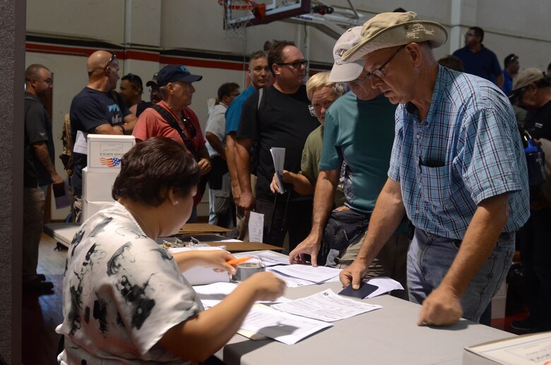 More than 125 Department of Defense members and contractors in-process at Andersen Air Force Base, Guam, July 15, 2015, after evacuation from Wake Island in preparation for potential surges caused by Typhoon Halola. The evacuees were transported aboard a C-17 Globemaster III assigned to the Hawaii Air National Guard from Joint Base Pearl Harbor-Hickam, Hawaii, in coordination with the 613th Air Operations Center at JBPHH and the Pacific Air Forces Regional Support Center at Joint Base Elmendorf-Richardson, Alaska. The DoD personnel are part of the PRSC and 11th Air Force mission on Wake Island, which is a strategic location within the Pacific and also a divert airfield for overseas flights. (U.S. Air Force photo by Airman 1st Class Alexa A. Henderson/Released)