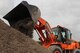 More dirt is added to an already existing hill as members of the 301st and 307th Civil Engineering Squadrons work on an airport runway in Clarksdale, Miss., June 30, 2015.   The Airmen spent almost two weeks helping to improve conditions at the airport and gaining valuable training experience.  (U.S. Air Force photo by Senior Airman Rodney Gibson/released)