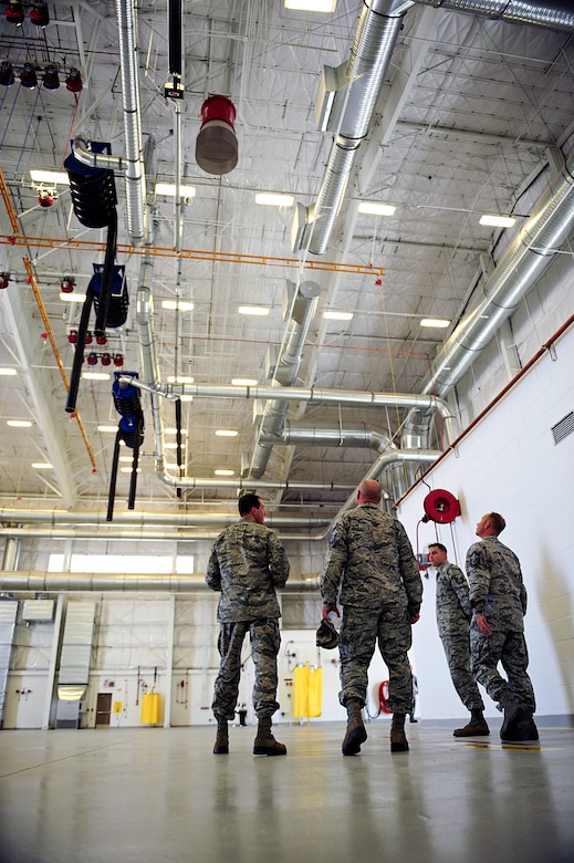 U.S. Air Force Col. James Meger, 355th Fighter Wing commander, receives a tour of the 355th Component Maintenance Squadron's new Joint fuel cell repair hangar after its ribbon cutting ceremony at Davis-Monthan Air Force Base, Ariz., July 13, 2015. The facility encompasses 29,000 square feet and is capable of housing one C-130 Hercules, or either two A-10 Thunderbolts or HH-60 Pavehawks. (U.S. Air Force photo by Airman 1st Class Chris Drzazgowski/Released)