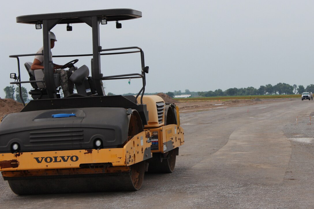 A U.S. Air Force Airmen with the 307th Civil Engineer Squadron grades a runway for the airport in Clarksdale, Miss., June 29, 2015.   The 307th CES and 301st CES teamed up to work on the airport as part of the Air Force Reserve Command's Innovative Readiness Training initiative.   The program allows AFRC units to help underserved communities while gaining training experience.  (U.S. Air Force photo by Senior Airman Rodney Gibson/released)