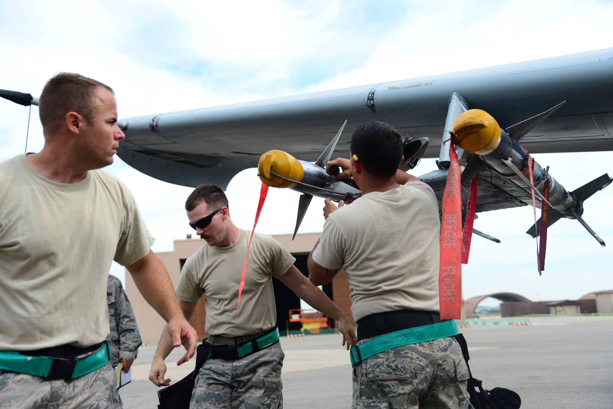 The 25th Aircraft Maintenance Unit load team completes loading an air-to-air missile onto their A-10 Thunderbolt II during the quarterly weapons load competition at Osan Air Base, Republic of Korea, July 10, 2015. The event adds an element of competition to a qualification test for the technicians; competitors must complete a written test and a practical demonstration of skill within a fixed amount of time in order to maintain mission readiness status. (U.S. Air Force photo/Staff Sgt. Amber Grimm)