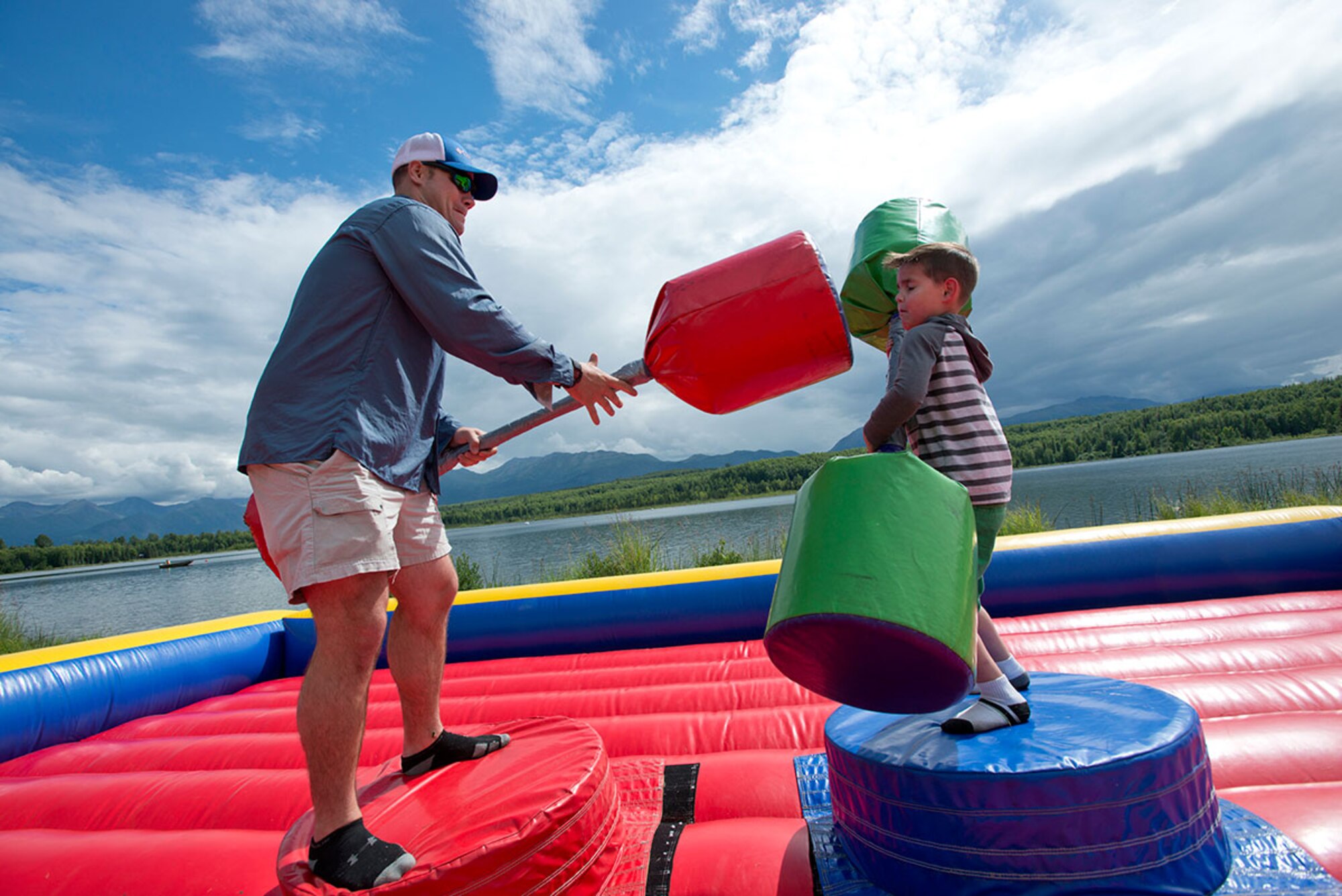 Army Staff. Sgt. John Gallogli battles his son, AJ, 6, with pugil sticks during Otterfest on Joint Base Elmendorf-Richardson, Alaska, July 11, 2015.  Otter Fest was organized and hosted by the JBER Outdoor Recreation Center. Gallogli is a squad leader for B Company, 1st Battalion (Airborne), 501st Infantry Regiment, 4th Infantry Brigade Combat Team (Airborne), 25th Infantry Division. (U.S. Air Force photo/Tech. Sgt. Robert Barnett)