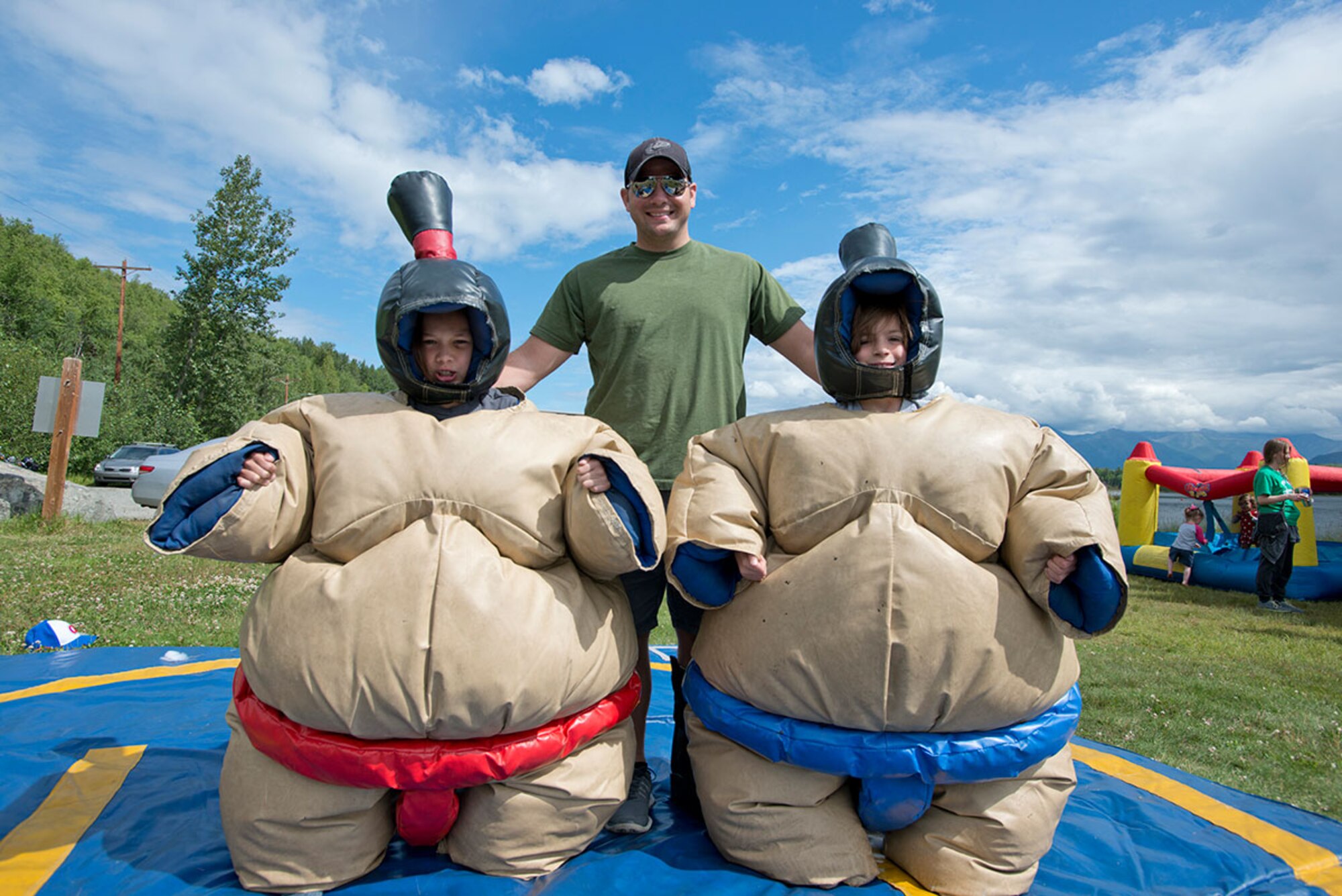 Air Force Staff Sgt. Thomas Lee poses with his sons, Petyon, 9, left, and Pierson, 8, right, during Otterfest on Joint Base Elmendorf-Richardson, Alaska, July 11, 2015. Lee is an aerospace medical services technician for the 673d Medical Operations Squadron. (U.S. Air Force photo/Tech. Sgt. Robert Barnett)