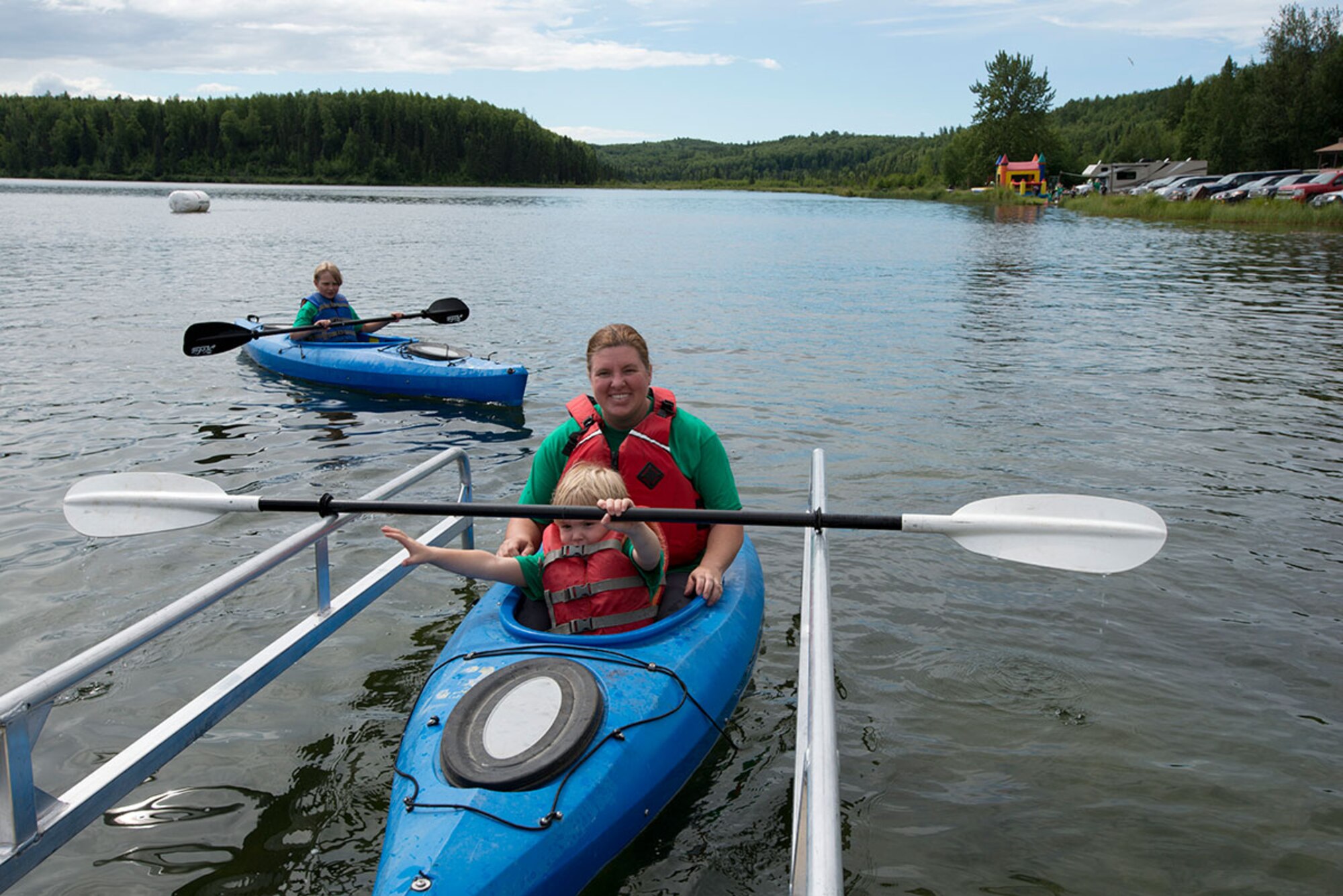 Kelly Johnson and her son, Donnie, 5, float their kayak into a dock after a water race during Otterfest on Joint Base Elmendorf-Richardson, Alaska, July 11, 2015. This year's Otterfest also included face-painting, a bouncy house, sumo suit wrestling, pugil stick fights and free food. (U.S. Air Force photo/Tech. Sgt. Robert Barnett)