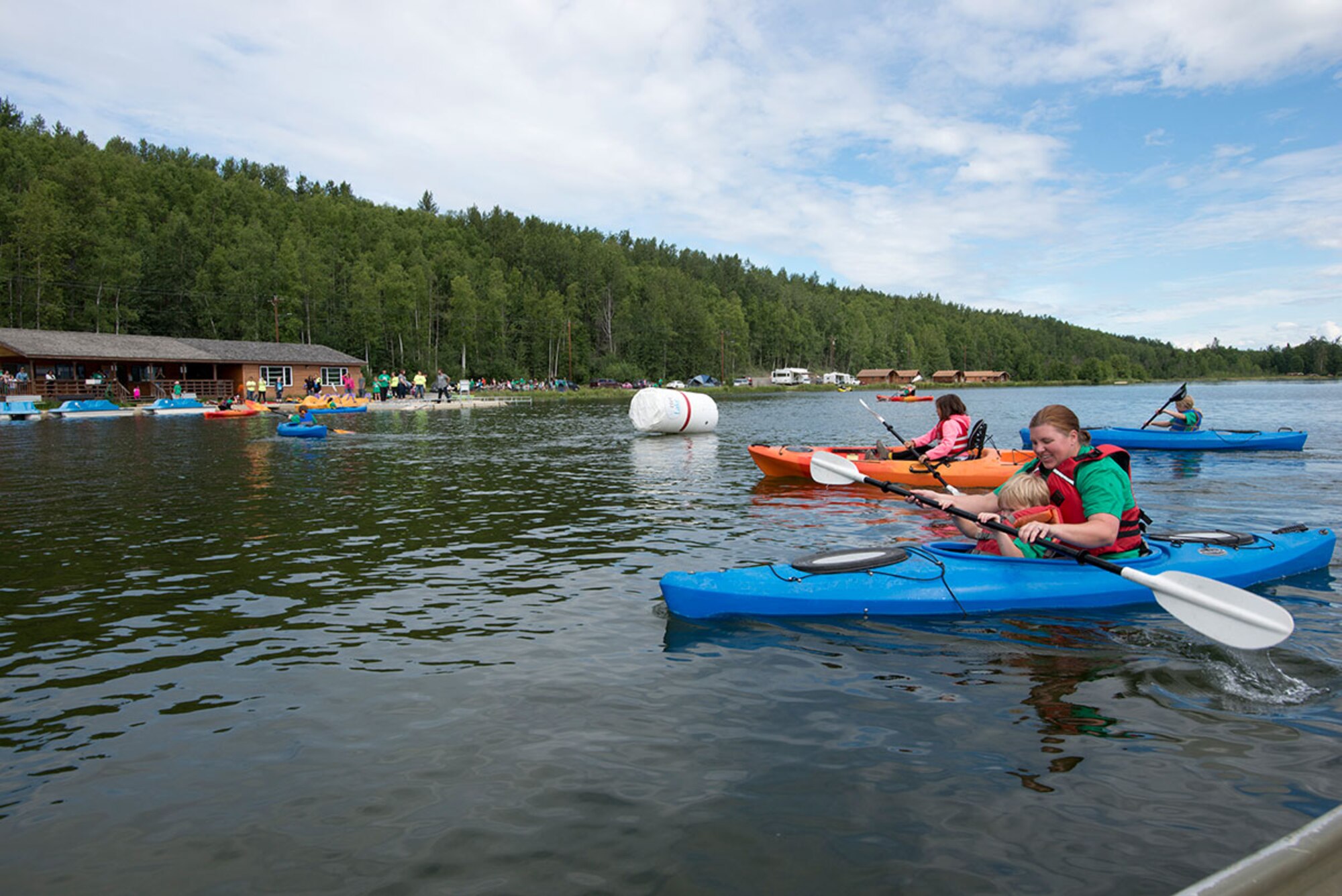 Kelly Johnson and her son, Donnie, 5, compete against other families in a kayak race during Otterfest on Joint Base Elmendorf-Richardson, Alaska, July 11, 2015. Otter Fest was organized and hosted by the JBER Outdoor Recreation Center. (U.S. Air Force photo/Tech. Sgt. Robert Barnett)