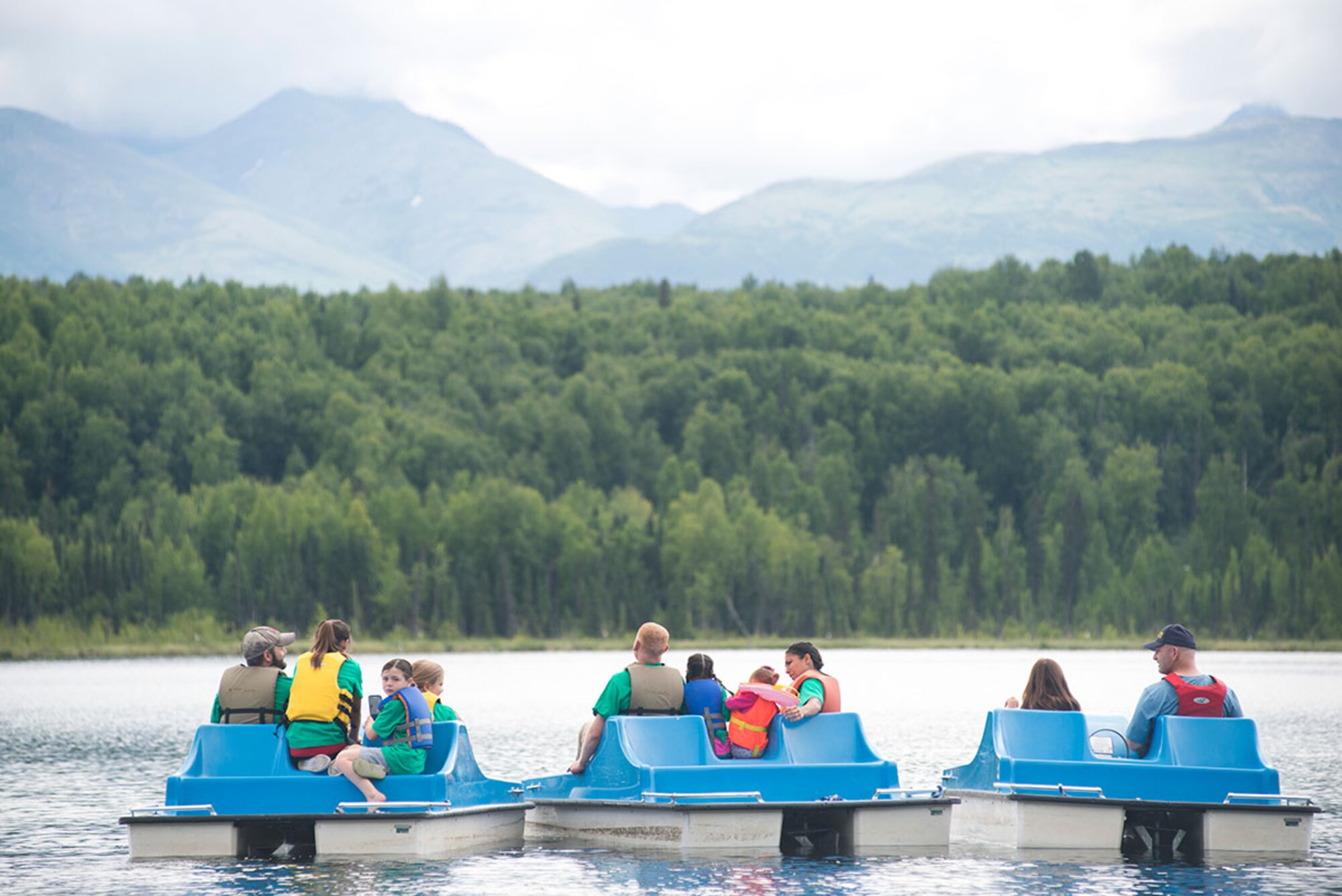 Military members and family members line up for a parent-child paddle boat race during the third annual Otterfest on Joint Base Elmendorf-Richardson, Alaska, July 11, 2015. The recreational family event was organized and hosted by the JBER Outdoor Recreation Center. This year's Otterfest also included face-painting, a bouncy house, sumo suit wrestling, pugil stick fights and free food. (U.S. Air Force photo/Tech. Sgt. Robert Barnett)