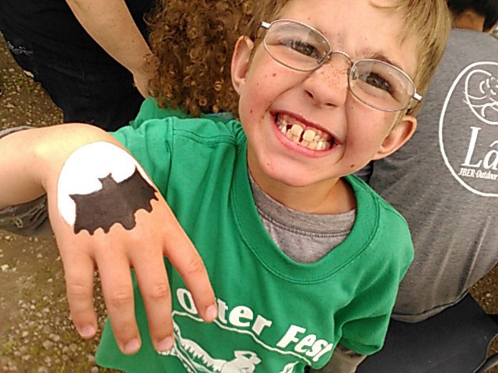 Logan Barnett, 8, shows off the artwork provided by a painter during Otterfest on Joint Base Elmendorf-Richardson, Alaska, July 11, 2015.  Otter Fest was organized and hosted by the JBER Outdoor Recreation Center. Otterfest took place from noon to 7 p.m. (U.S. Air Force photo/Tech. Sgt. Robert Barnett)