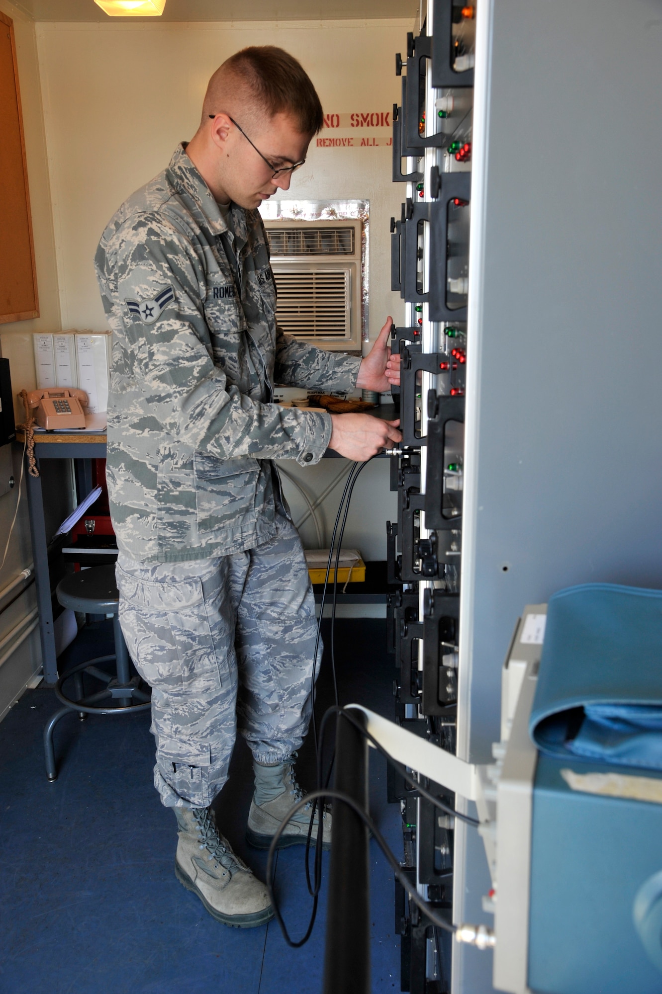 Airman 1st Class Eli Romesburg, 92nd Operations Support Squadron airfield systems specialist, checks the signal from the localizer antenna array July 14, 2015, at Fairchild Air Force Base, Wash. The localizer sends a signal so aircraft can see up to 20 miles away ensuring they are in the right direction. Romesburg checks the signal to verify it is at the correct output to certify the aircraft will be able to align with the center of the runway for the safest landing. (U.S. Air Force photo/Airman 1st Class Taylor Bourgeous)