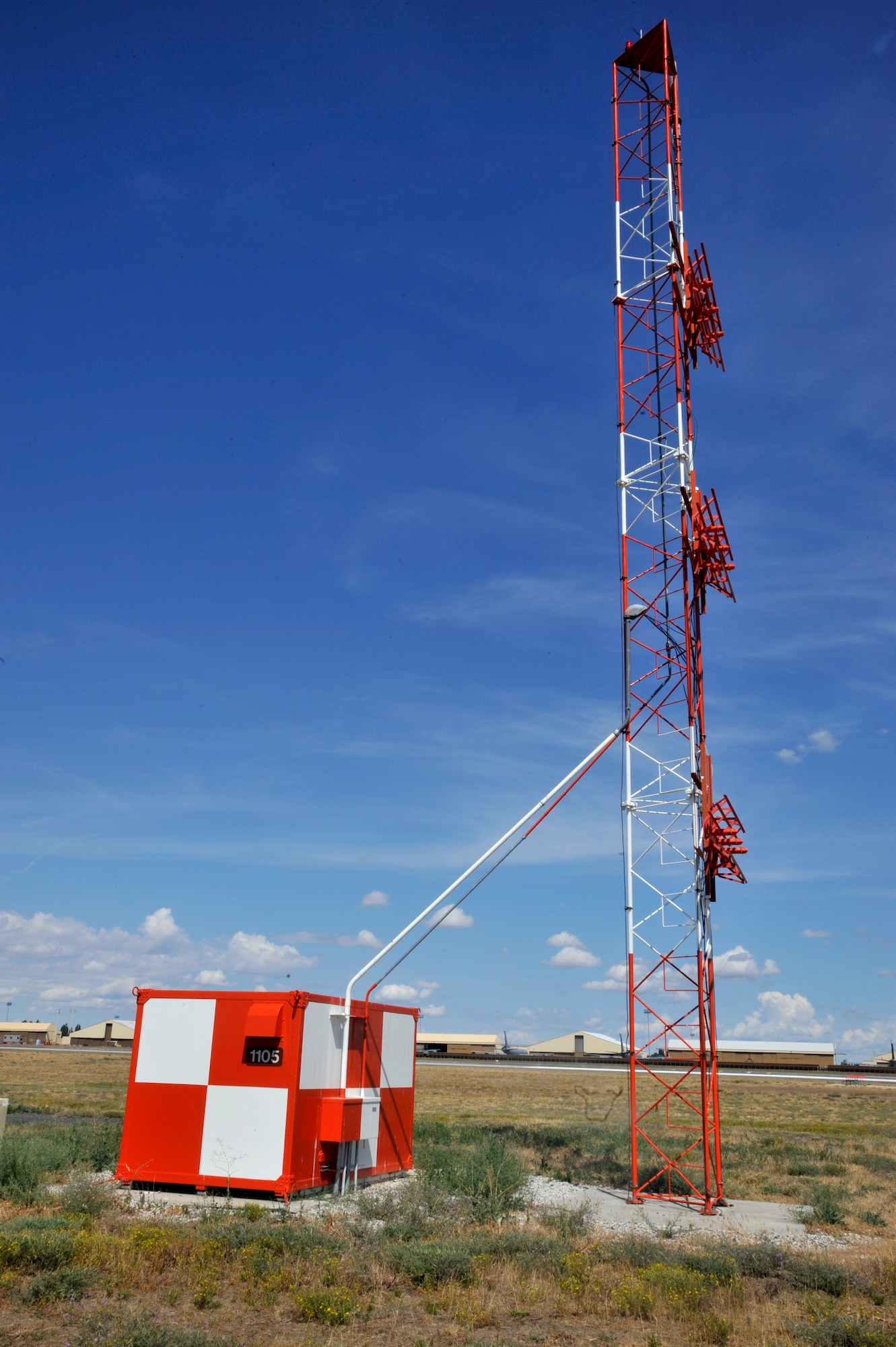A glide slope antenna is seen on the airfield July 14, 2015, at Fairchild Air Force Base, Wash. The glide slope radiates the signal aircraft use to ensure they are on the right path, the instrument guides the aircraft to the right angle for a safe landing on the runway. This system is maintained by the 92nd Operation Support Squadron airfield systems specialists. Without them, the air traffic controllers and pilots would not be able to accomplish their jobs. (U.S. Air Force photo/Airman 1st Class Taylor Bourgeous)